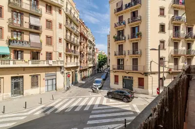 a city street with a car parked in front of buildings at GuestReady - Bright apartment with balcony in Barcelona