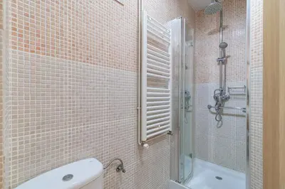 a bathroom with a shower and a toilet and a sink at GuestReady - Bright apartment with balcony in Barcelona