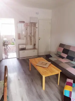 a living room with a couch and a table at Apartment close to the beach and the town centre in Castelldefels