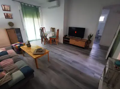 a living room with a couch and a table at Apartment close to the beach and the town centre in Castelldefels