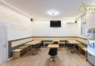 a classroom with tables and chairs and a tv at Hostal Oliveta Budget in Barcelona