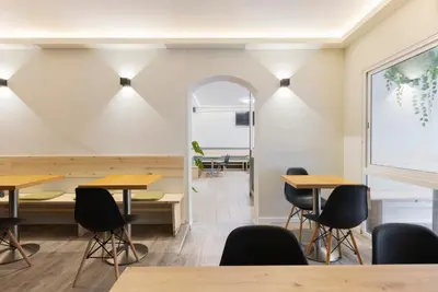 a room with tables and chairs and a window at Hostal Oliveta Budget in Barcelona