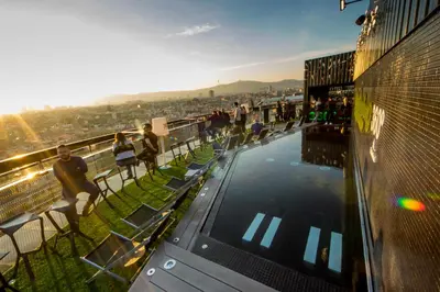 a group of people standing around a pool on a building at Barceló Raval in Barcelona