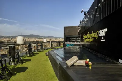 a view of a rooftop bar with a hot tub at Barceló Raval in Barcelona