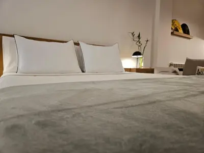 a large bed with white pillows in a bedroom at EstudioSueñosSuite in Sant Just Desvern