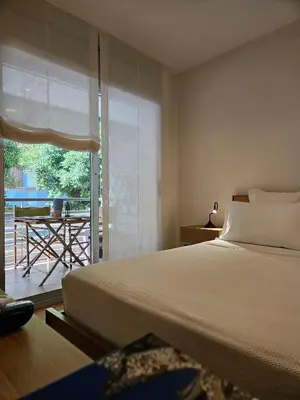 a bedroom with a bed and a view of a patio at EstudioSueñosSuite in Sant Just Desvern