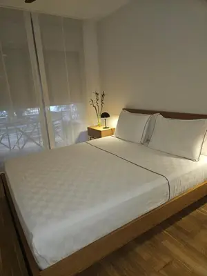 a bedroom with a large white bed with a window at EstudioSueñosSuite in Sant Just Desvern