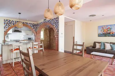 a kitchen and living room with a table and a couch at GuestReady - Un pequeño paraíso en Barcelona in Barcelona