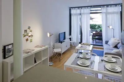 a living room with a couch and a table at Flateli Llúria in Barcelona