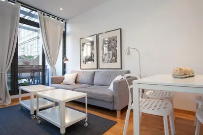 a living room with a couch and a table at Flateli Llúria in Barcelona