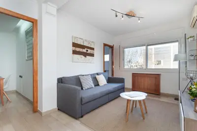 a living room with a couch and a table at Flateli Lepant in Barcelona