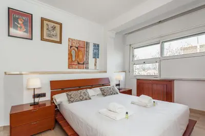 a bedroom with a bed with two towels on it at Flateli Lepant in Barcelona