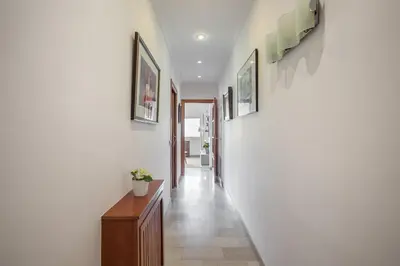 a hallway of a home with white walls and a staircase at Flateli Lepant in Barcelona