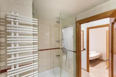 a bathroom with a shower and a glass door at Flateli Lepant in Barcelona