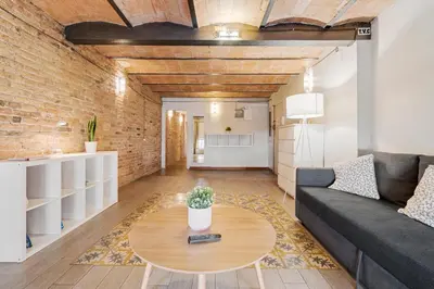 a living room with a couch and a table at Flateli Fabra in Barcelona