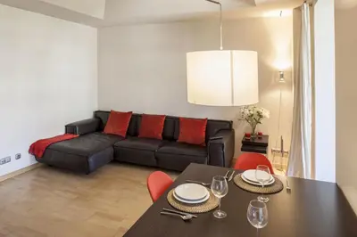 a living room with a black couch and a table at Flateli Mallorca-Passeig de Gracia in Barcelona