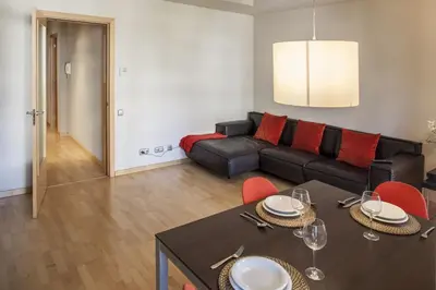 a living room with a black couch and red pillows at Flateli Mallorca-Passeig de Gracia in Barcelona