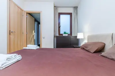 a bedroom with a large bed and a window at Flateli Mallorca-Passeig de Gracia in Barcelona