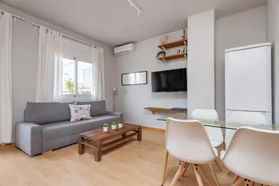 a living room with a couch and a glass table at Flateli Roger 16 in Barcelona