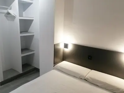 a bedroom with a bed with a black headboard at La Fira - Paralelo 1 in Barcelona