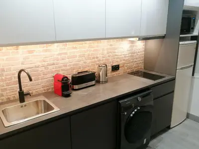 a kitchen counter with a sink and a toaster at La Fira - Paralelo 1 in Barcelona