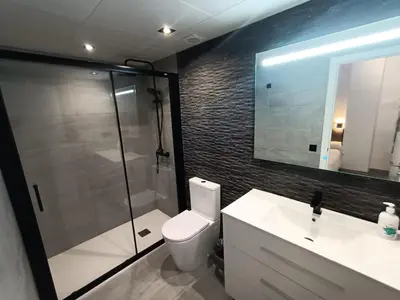 a bathroom with a shower and a toilet and a sink at La Fira - Paralelo 1 in Barcelona