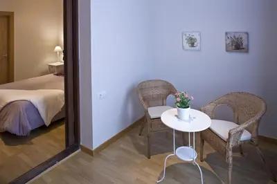 a room with a table and two chairs and a bed at Flateli Pelayo H1 in Barcelona