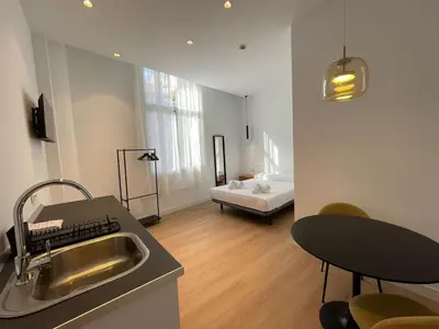a kitchen with a sink and a bed in a room at Hotelito Boutique Badalona Gran Villa in Badalona
