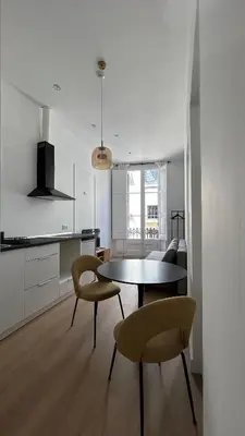 a kitchen and dining room with a table and chairs at Hotelito Boutique Badalona Gran Villa in Badalona