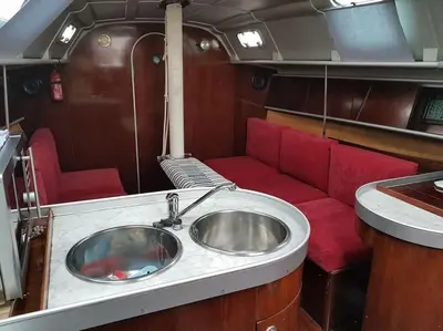 a bathroom with a sink and a red couch at AMAZING FLAT IN CLASSIC SAILING BOAT in BARCELONA in Barcelona