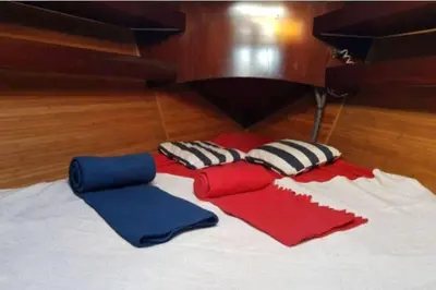 a group of pillows on a bed with a piano at AMAZING FLAT IN CLASSIC SAILING BOAT in BARCELONA in Barcelona