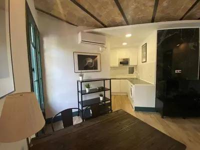 a living room with a fireplace and a table at Barcelona Rent - Gaudi House in Barcelona
