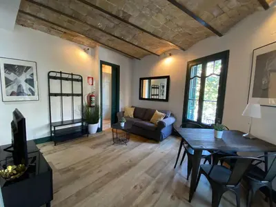 a living room with a couch and a table at Barcelona Rent - Gaudi House in Barcelona
