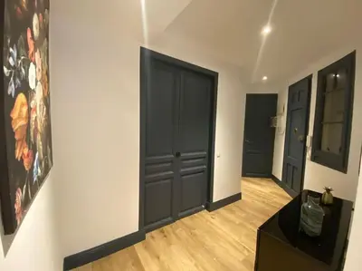a room with black doors and a wooden floor at Barcelona rent - Picasso House in Barcelona