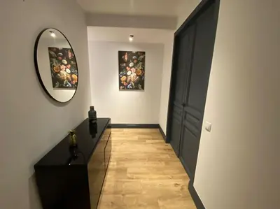 a hallway with a black door and a mirror at Barcelona rent - Picasso House in Barcelona