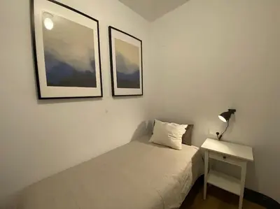 a bedroom with a bed and a table with a lamp at Barcelona rent - Picasso House in Barcelona