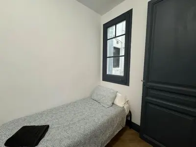 a small bedroom with a bed and a window at Barcelona rent - Picasso House in Barcelona