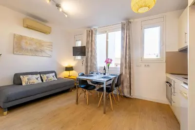 a living room with a couch and a table at Modern Apartment 2 rooms 15' Bcn Center - Fira Barcelona in Barcelona