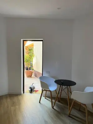 a room with a table and chairs and a door at Acogedor piso independiente Valldoreix in Sant Cugat del Vallès