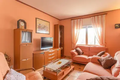 a living room with a couch and a tv at Cal Vimón in Las Masucas
