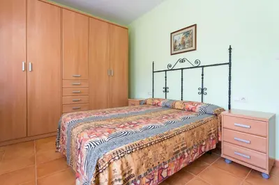 a bedroom with a bed and a dresser at Cal Vimón in Las Masucas