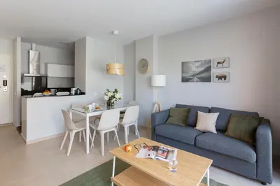 a living room with a blue couch and a table at 4235 - AB Santa Coloma 3 B-I in Santa Coloma