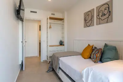 a small bedroom with two beds and a bathroom at 4236 - AB Santa Coloma III in Santa Coloma