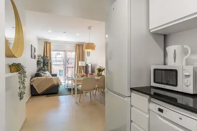 a kitchen with a microwave and a dining room at 4237 - AB Santa Coloma III in Santa Coloma