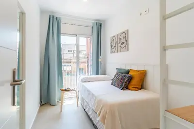 a small bedroom with a bed and a window at 4237 - AB Santa Coloma III in Santa Coloma
