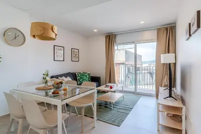 a dining room and living room with a table and chairs at 4238 - AB Duplex Santa Coloma III in Santa Coloma