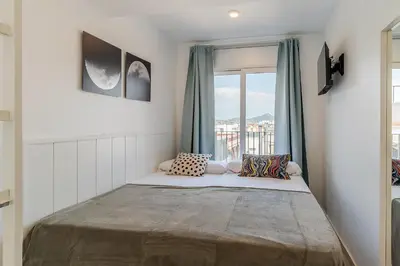 a bed in a room with a window at 4238 - AB Duplex Santa Coloma III in Santa Coloma