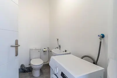 a white bathroom with a toilet and a sink at 4238 - AB Duplex Santa Coloma III in Santa Coloma