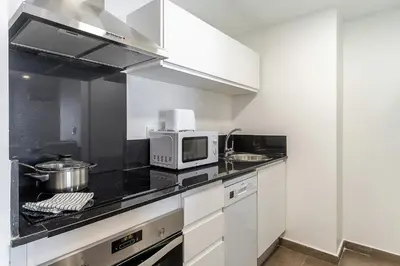 a kitchen with white cabinets and a microwave at 4238 - AB Duplex Santa Coloma III in Santa Coloma