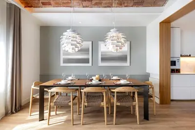 a dining room with a black table and chairs at Luxury Apt with King Beds & Central AC in Heart of BCN in Barcelona